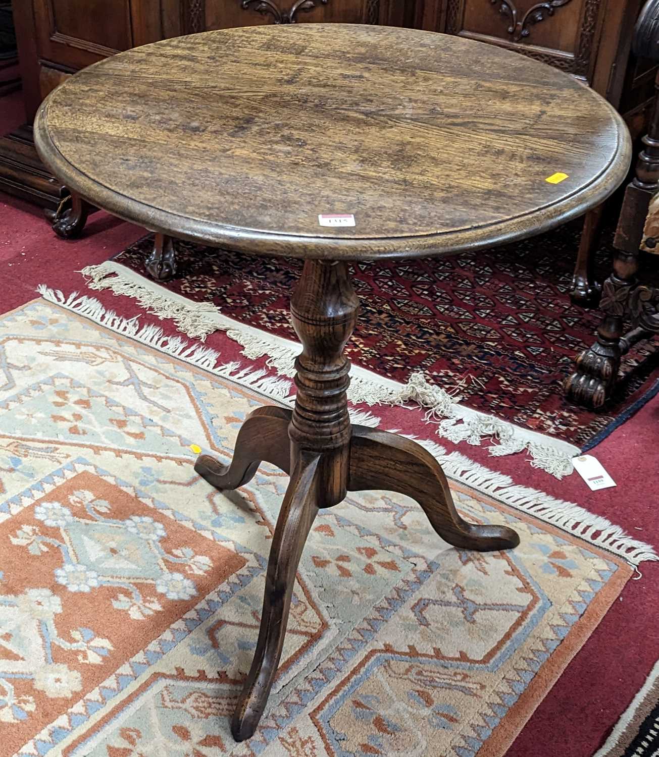 A contemporary oak circular tilt-top pedestal tripod table, on hipped supports, dia.62cm