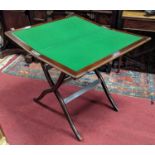 An early 20th century mahogany and gunmetal mounted campaign table, having baize lined interior