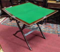 An early 20th century mahogany and gunmetal mounted campaign table, having baize lined interior