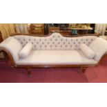 A Regency mahogany scroll-end four-seater sofa, floral button back fabric upholstered, raised on