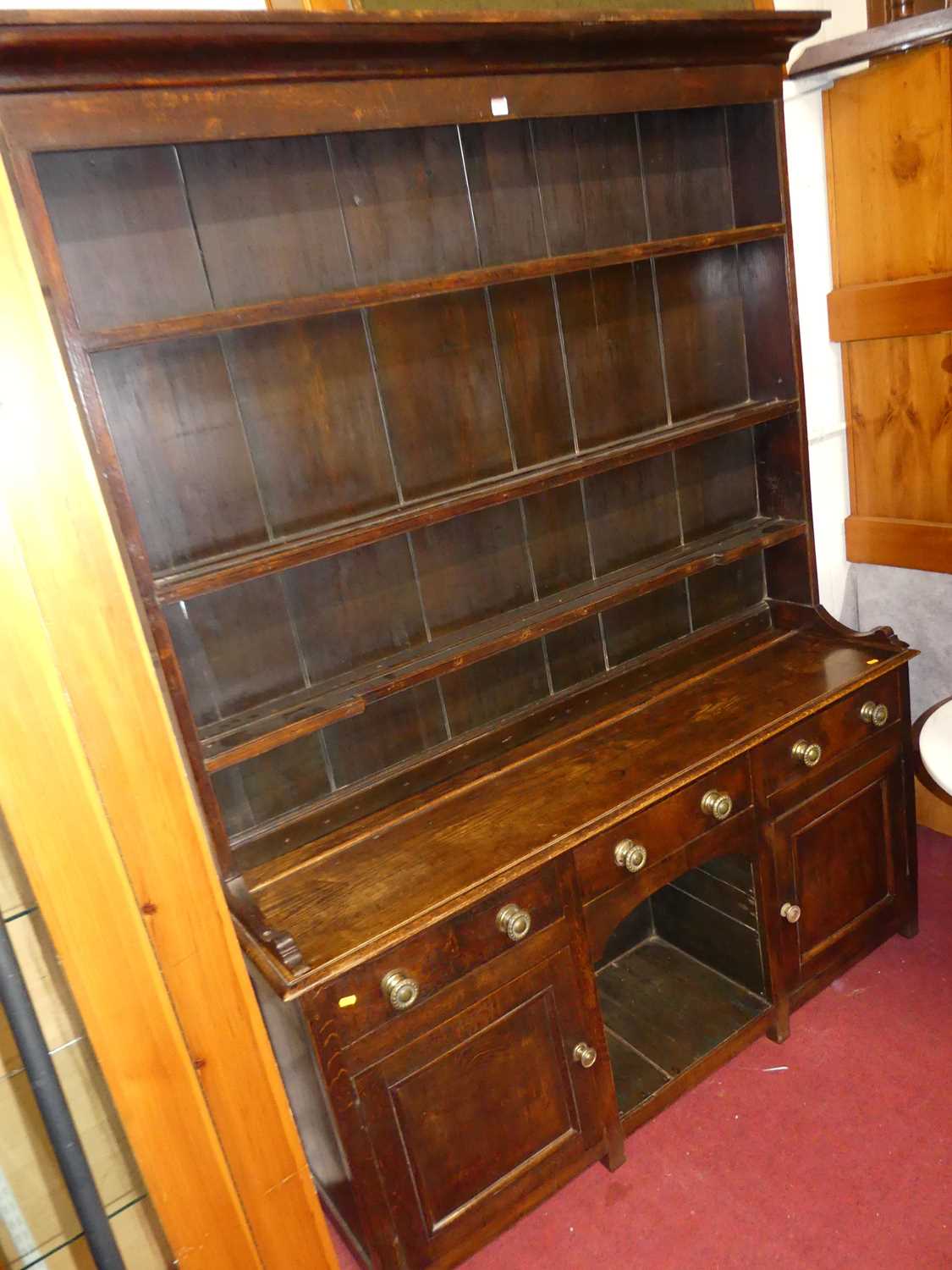 A circa 1800 provincial oak dresser, having three-tier open plate rack over base fitted with three