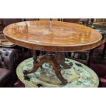 A mid-Victorian figured walnut oval tilt-top pedestal breakfast table, raised on fluted and acanthus