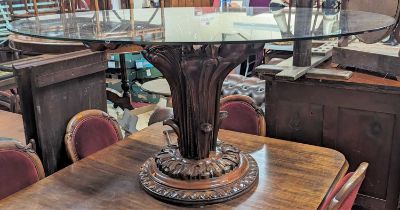 A contemporary heavy glass oval topped and acanthus leaf floral carved cherrywood based pedestal