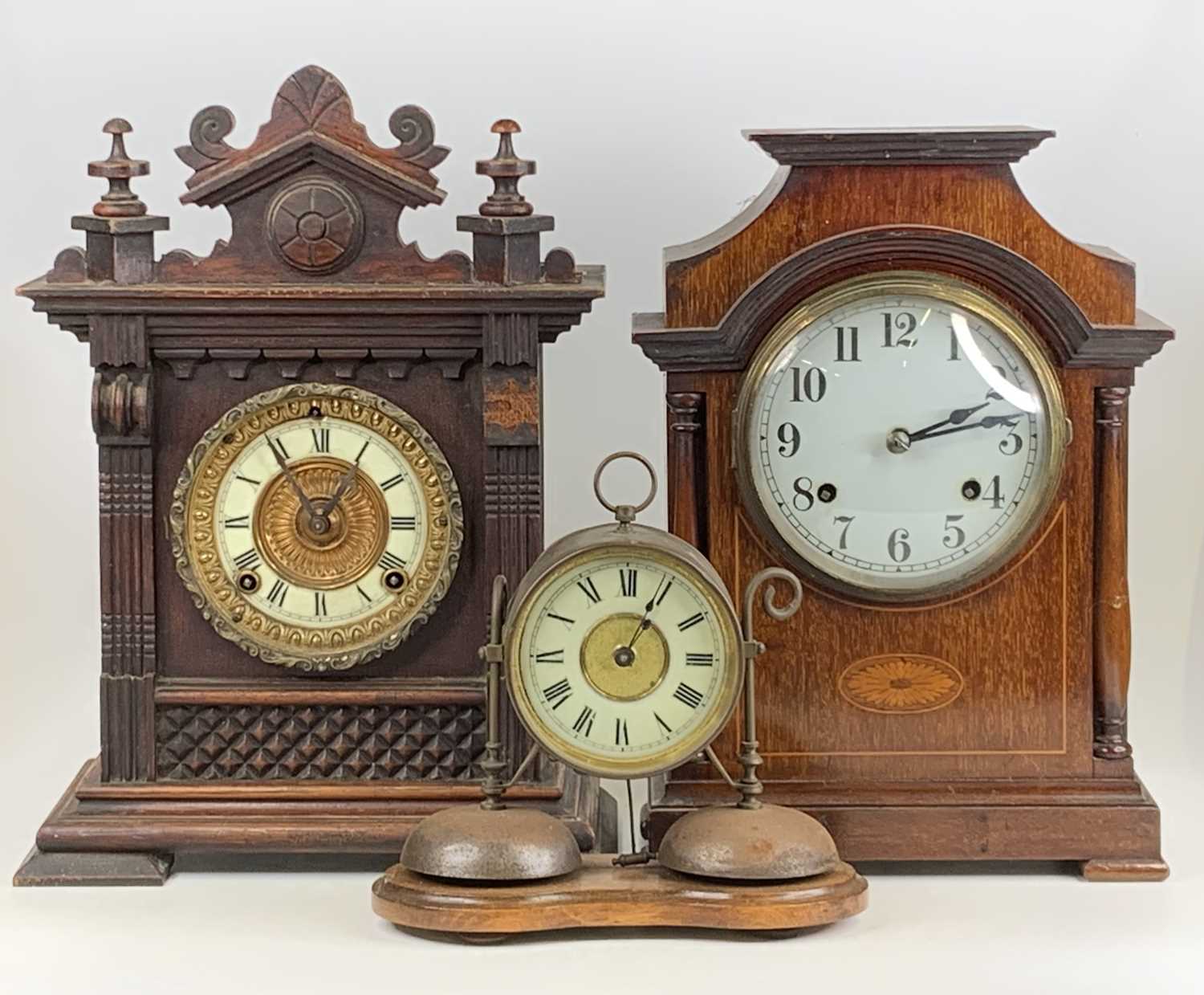 An Edwardian inlaid mahogany mantel clock, having unsigned white enamel dial and spring-driven