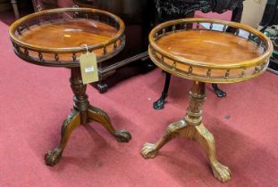 A pair of contemporary cherry wood circular pedestal tripod tables, each with raised balustrade tops