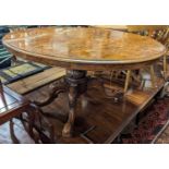 A mid-Victorian figured walnut oval tilt-top pedestal breakfast table, raised on acanthus carved and