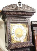 An antique oak long case clock having a 10½" square brass dial, silver chapter ring, single hand,