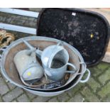 Two galvanised metal twin handled baths, together with two further watering cans, doorstop, and a