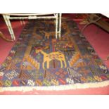 A Turkish woollen multi-coloured ground pictorial rug, with stylised design of animals and