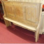 A rustic joined and panelled pine bench settle, of narrow profile, length 158cm