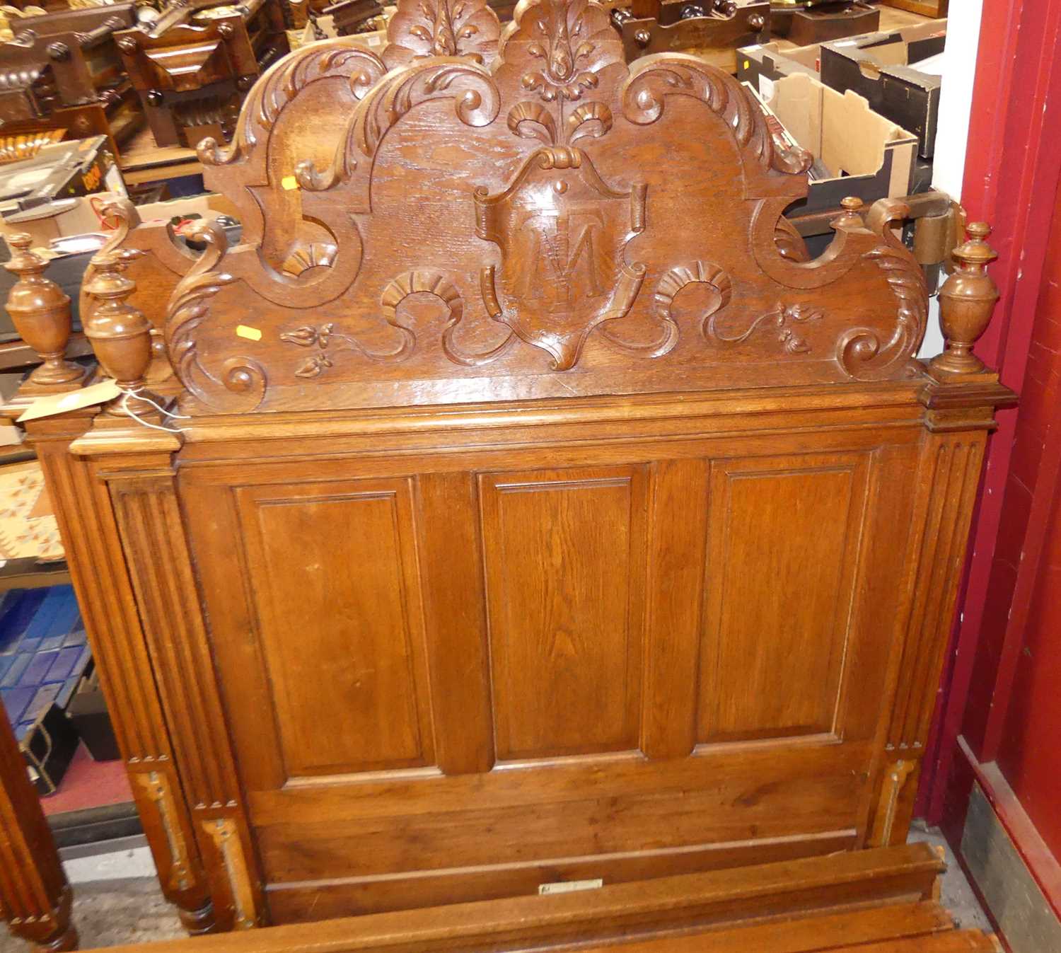An early 20th century Belgian panelled oak single bedstead, having floral shaped and carved