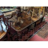 A Victorian mahogany round cornered extending dining table, having wind-out action, three extra