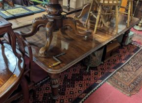 A Victorian mahogany round cornered extending dining table, having wind-out action, three extra