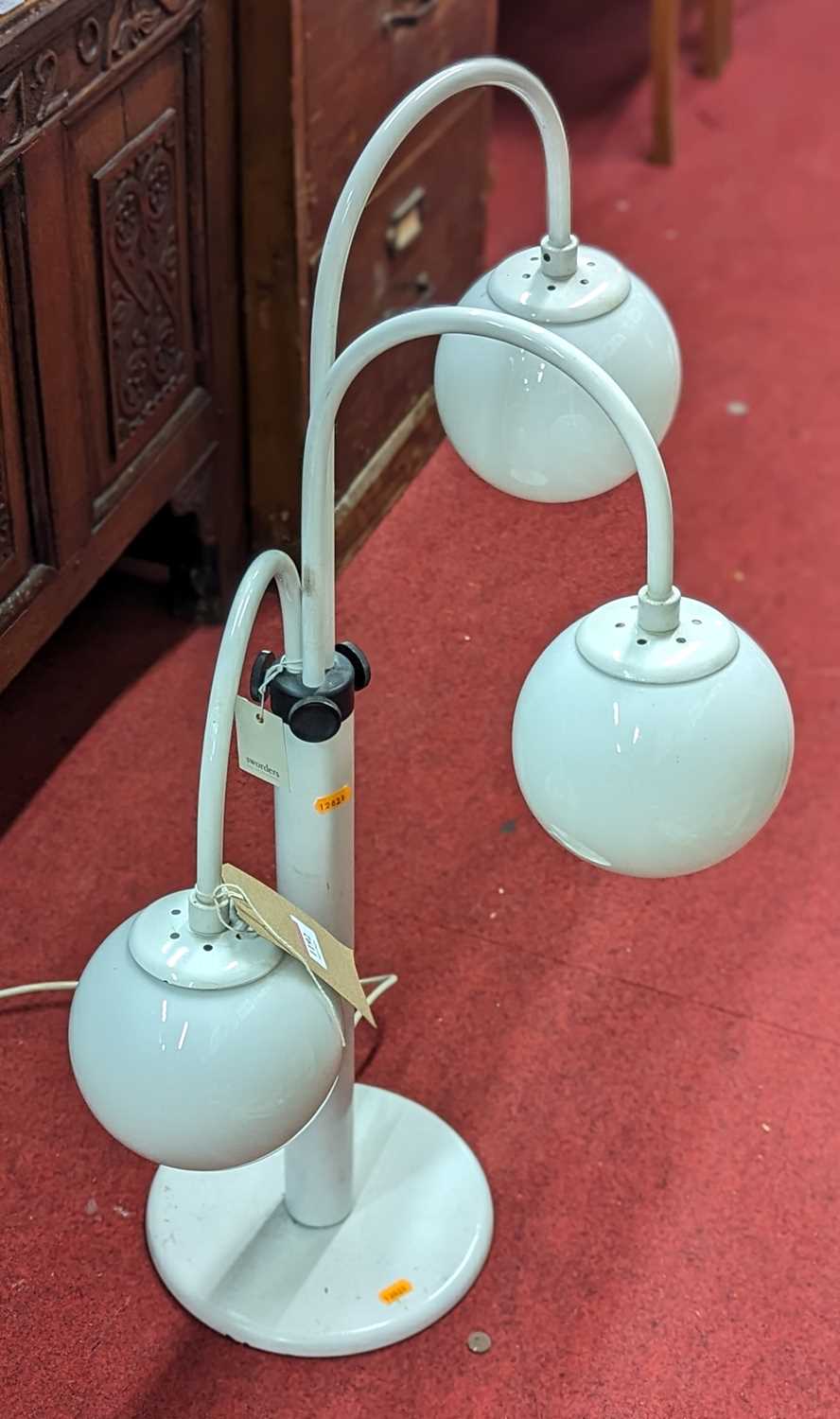 A 1980s white painted metal three-branch table lamp, the graduated movable branch arms with white