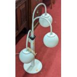 A 1980s white painted metal three-branch table lamp, the graduated movable branch arms with white