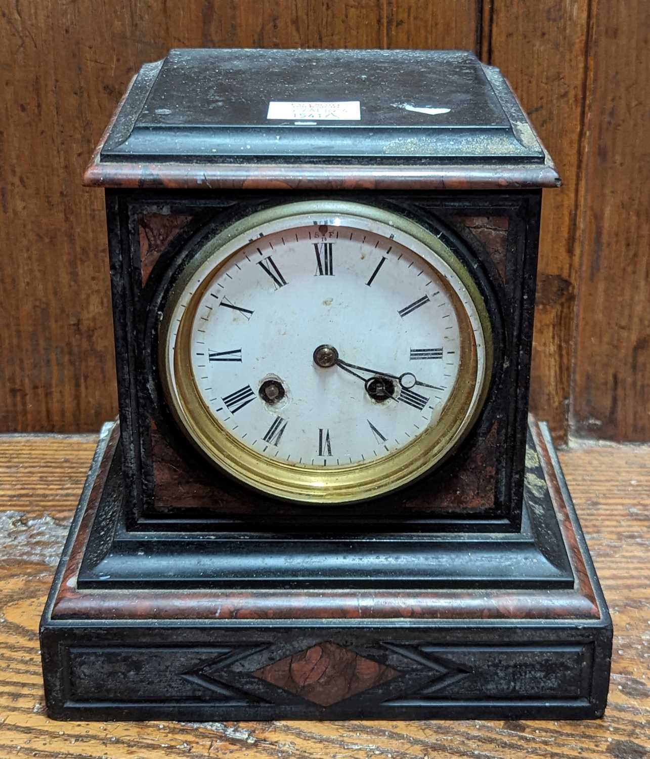 A Victorian black slate and rouge marble mantel clock