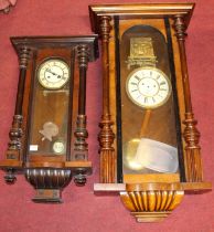 An early 20th century Vienna walnut cased drop trunk wall clock having spring driven movement