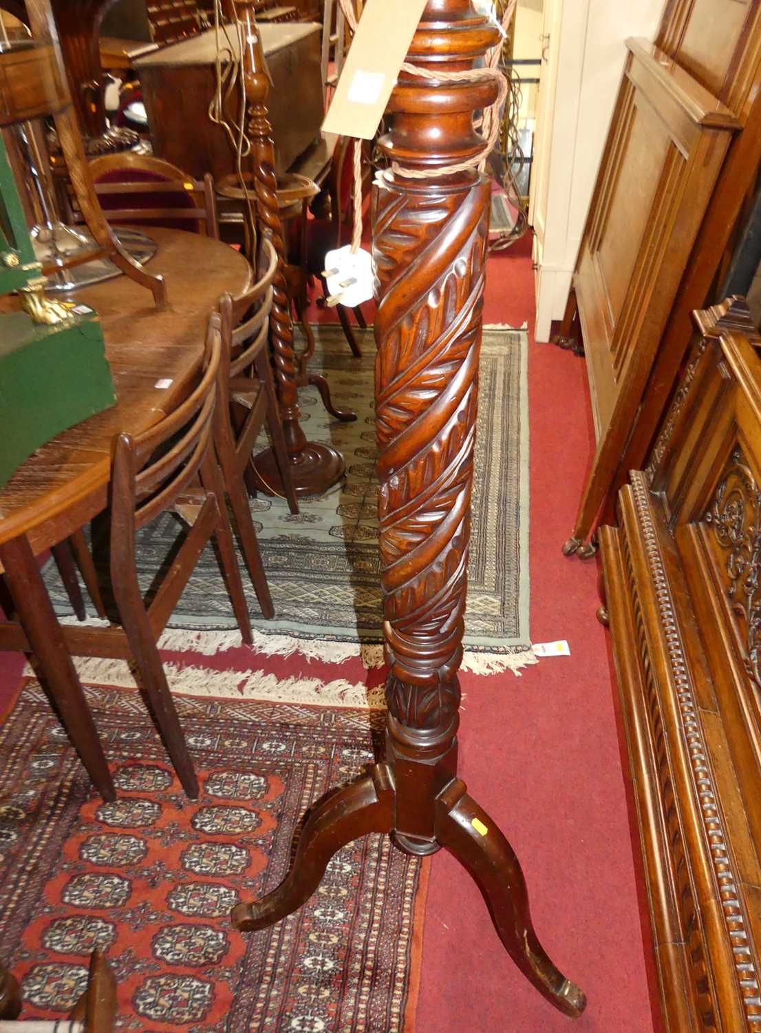 A mahogany acanthus leaf spiral turned standard lamp, raised on tripod hip supports (converted - Image 2 of 2