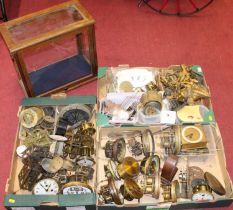 Three boxes of assorted clock parts, to include gilt metal figures, assorted cylindrical dials,