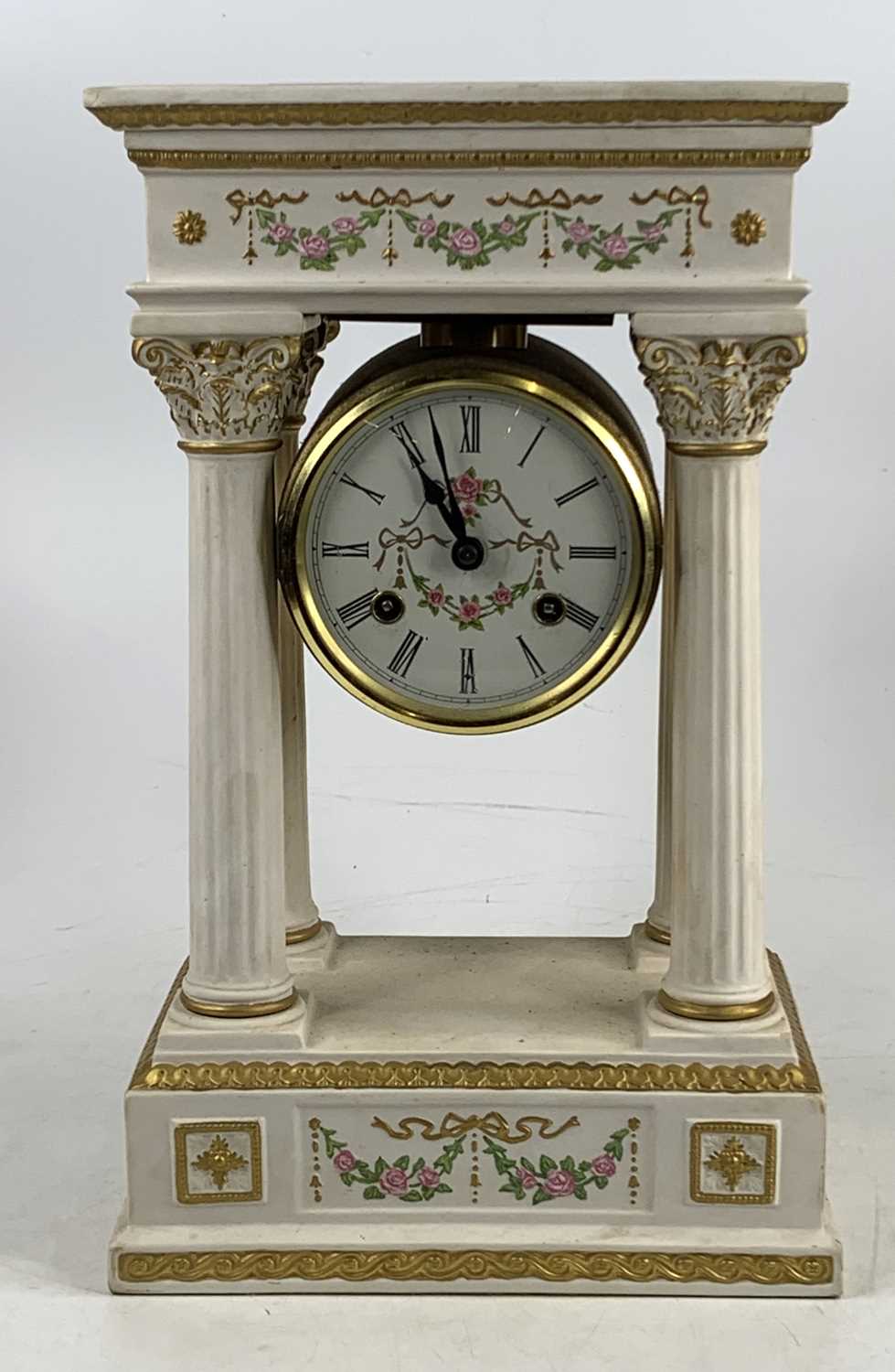 An early 20th century continental painted bisque portico clock, having unsigned painted white enamel