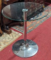 A contemporary glass topped and chromed metal based circular cafe table, dia.70cm