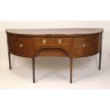 A George III mahogany and inlaid demi-lune sideboard, of large proportions, having a centre frieze