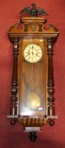 An early 20th century Vienna walnut cased drop trunk wall clock having eagle pediment, height 120cm
