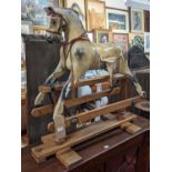 A vintage Triang dapple grey child's rocking horse, raised on a beech base with opposing labels to