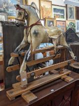 A vintage Triang dapple grey child's rocking horse, raised on a beech base with opposing labels to
