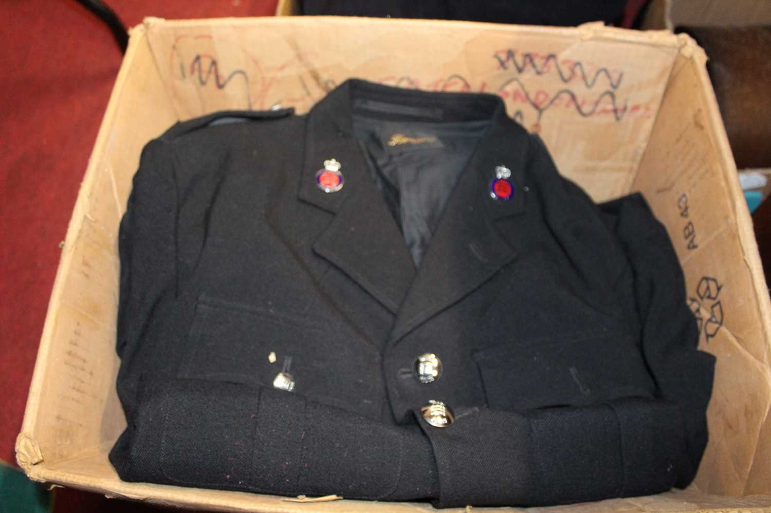 Four boxes of assorted police uniforms, to include tunics etc