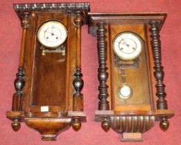 An early 20th century walnut cased Vienna drop trunk wall clock having spring driven movement,
