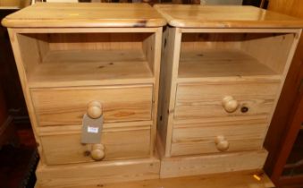 A pair of modern pine round cornered two drawer bedside tables, each with open upper compartments,