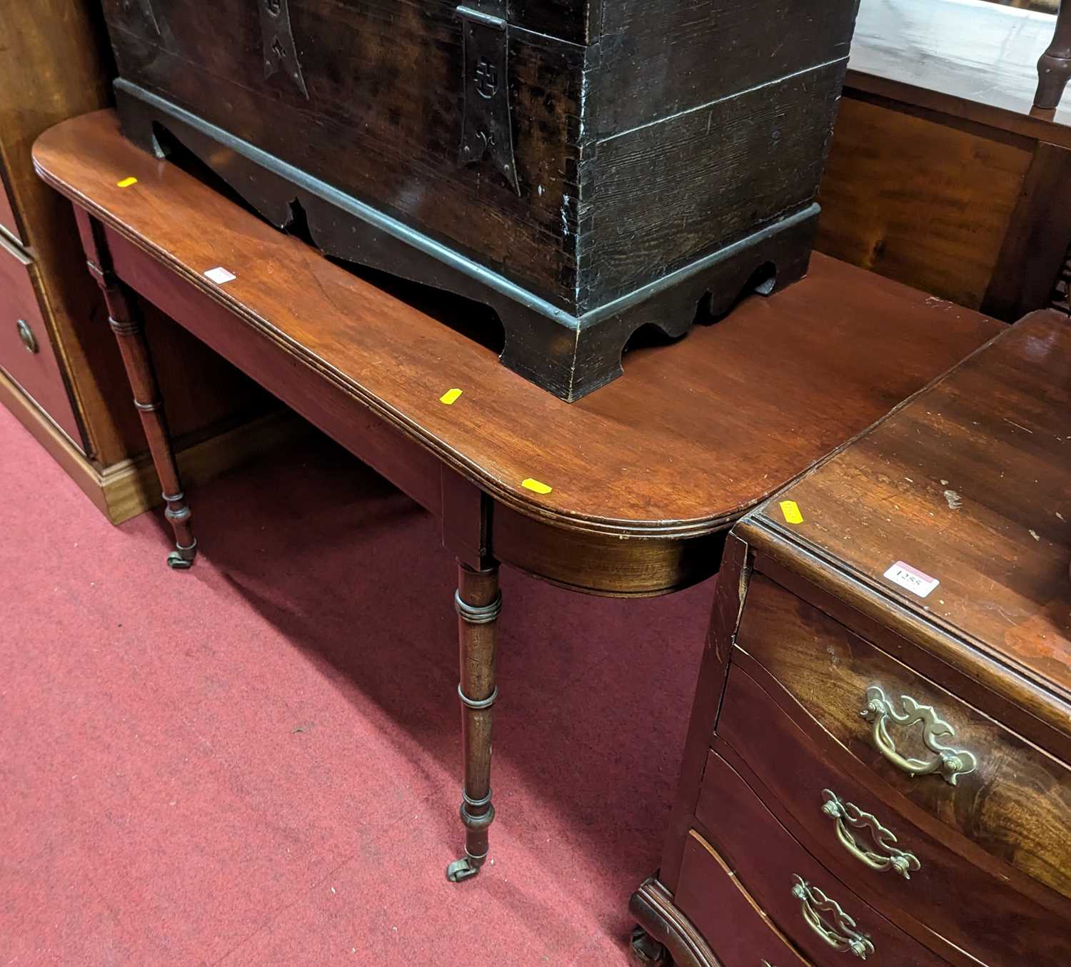 An early 19th century mahogany D-end side table, raised on ring turned supports, width 120cm