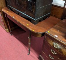 An early 19th century mahogany D-end side table, raised on ring turned supports, width 120cm