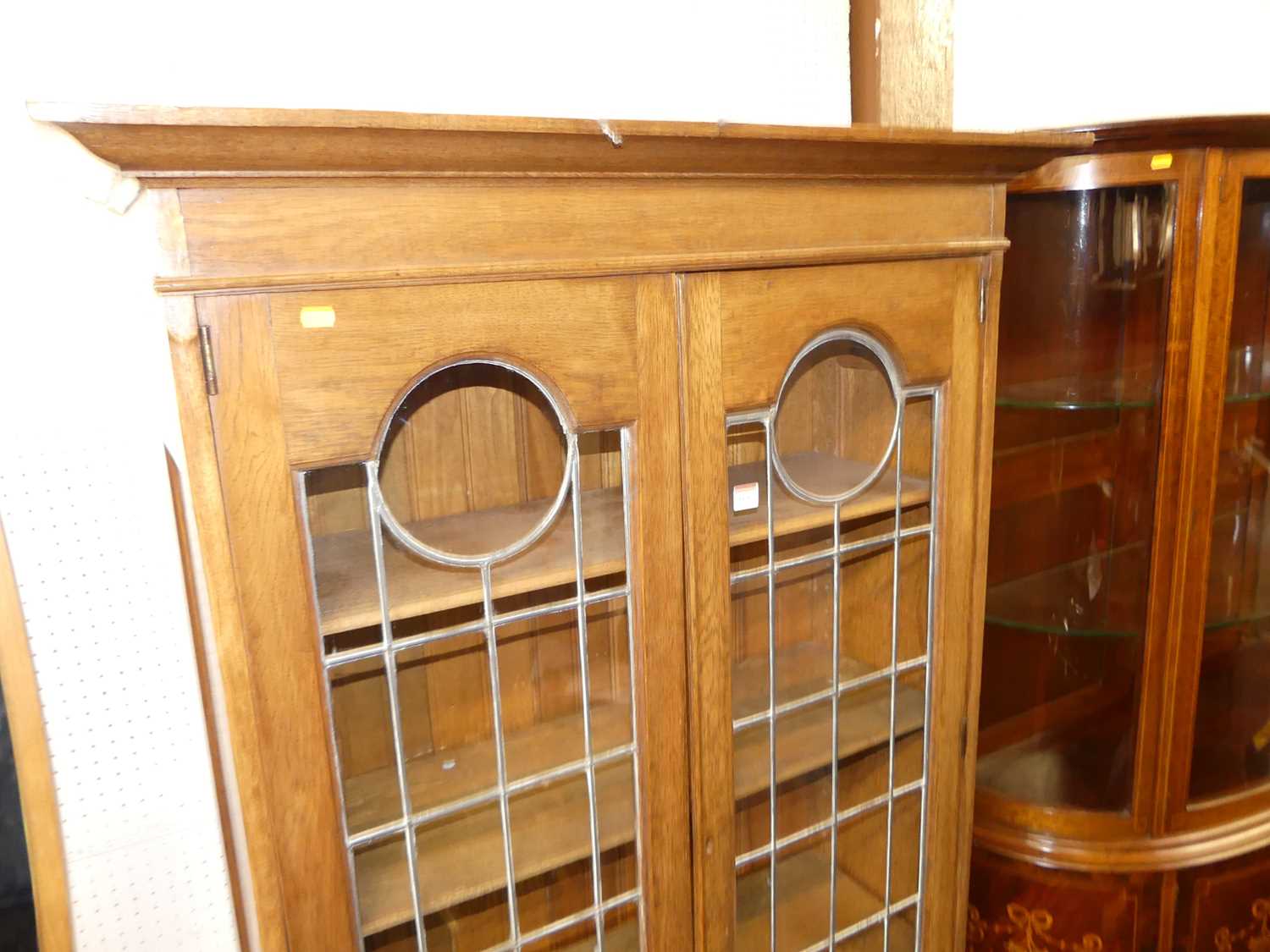An Arts & Crafts oak double door lead glazed bookcase, with interior shelves over floral stylised - Image 2 of 4