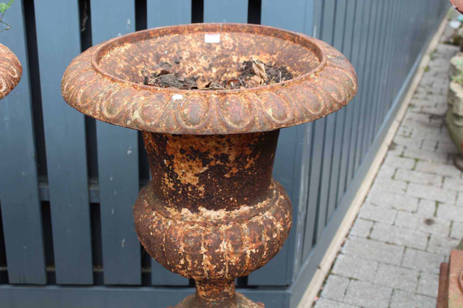 A pair of cast iron pedestal garden urns, each of reeded lower bulbous form and raised on square - Image 3 of 4