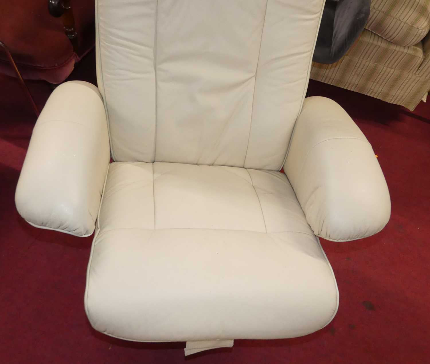 A contemporary cream leather upholstered swivel armchair, with matching footstool, on circular - Image 3 of 3