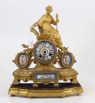 A mid 19th century French gilt metal and porcelain mantel clock having brass eight-day cylinder