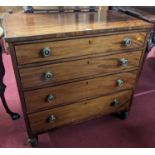 A Regency mahogany and ebony strung square front chest of four long graduated drawers on squat