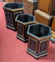 A pair of contemporary black and gilt painted hexagonal wastepaper bins; together with a larger