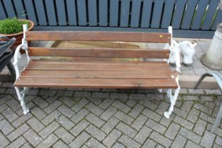 A white painted cast iron ended and hardwood slatted three-seater garden bench, in the Coalbrookdale