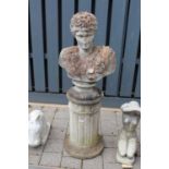 A reconstituted stone garden pedestal bust of Apollo, raised on a circular fluted base, overall