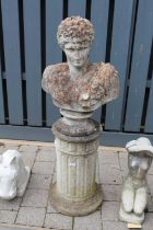 A reconstituted stone garden pedestal bust of Apollo, raised on a circular fluted base, overall