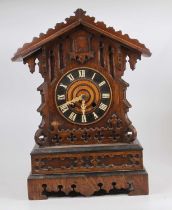 An early 20th century Black Forest oak mantel clock, height 48cm