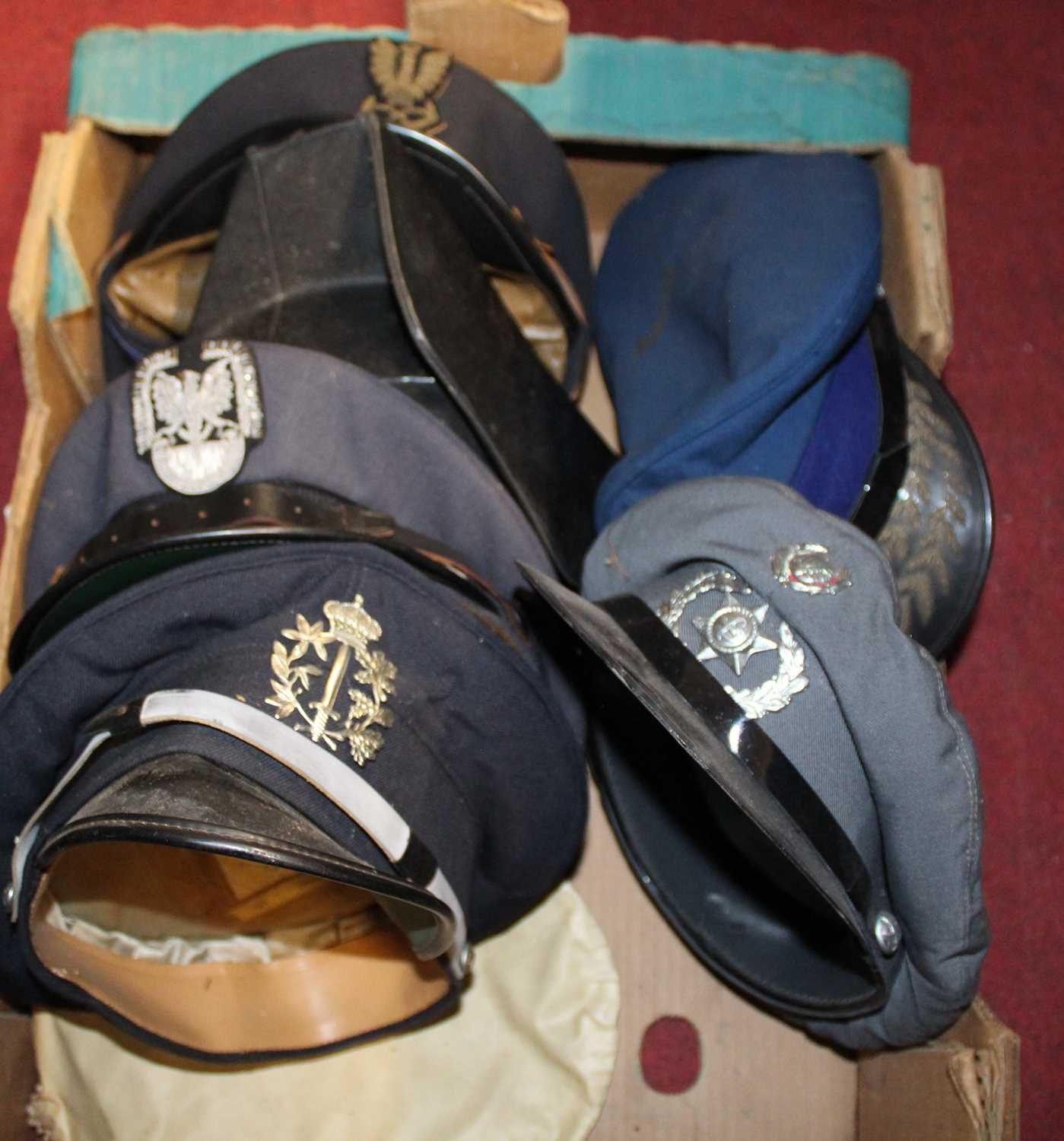 Two boxes of assorted headwear, mainly being police examples
