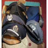 Two boxes of assorted headwear, mainly being police examples