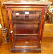 A stained mahogany single door glazed table-top display cabinet, w.38cm