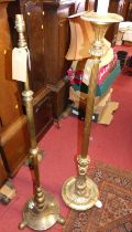 A gilt wood floral decorated and fluted standard lamp, together with a brass standard lamp with rise