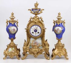 A reproduction French gilt metal and porcelain three-piece clock garniture, the clock with eight-day