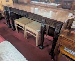 A large mahogany inverted breakfront servery, having floral carved and acanthus leaf decorated